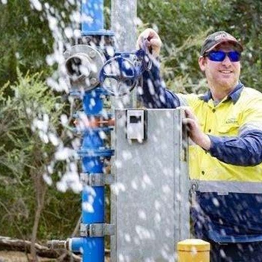 Man opening up bulk water installation.