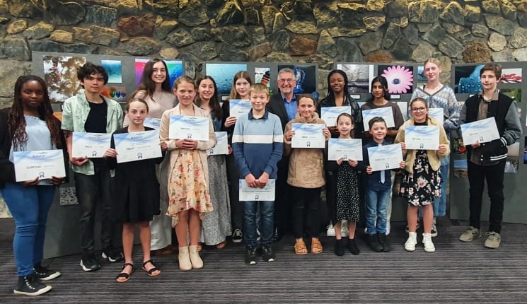 Winners of the 2021 photography competition holding their certificates.